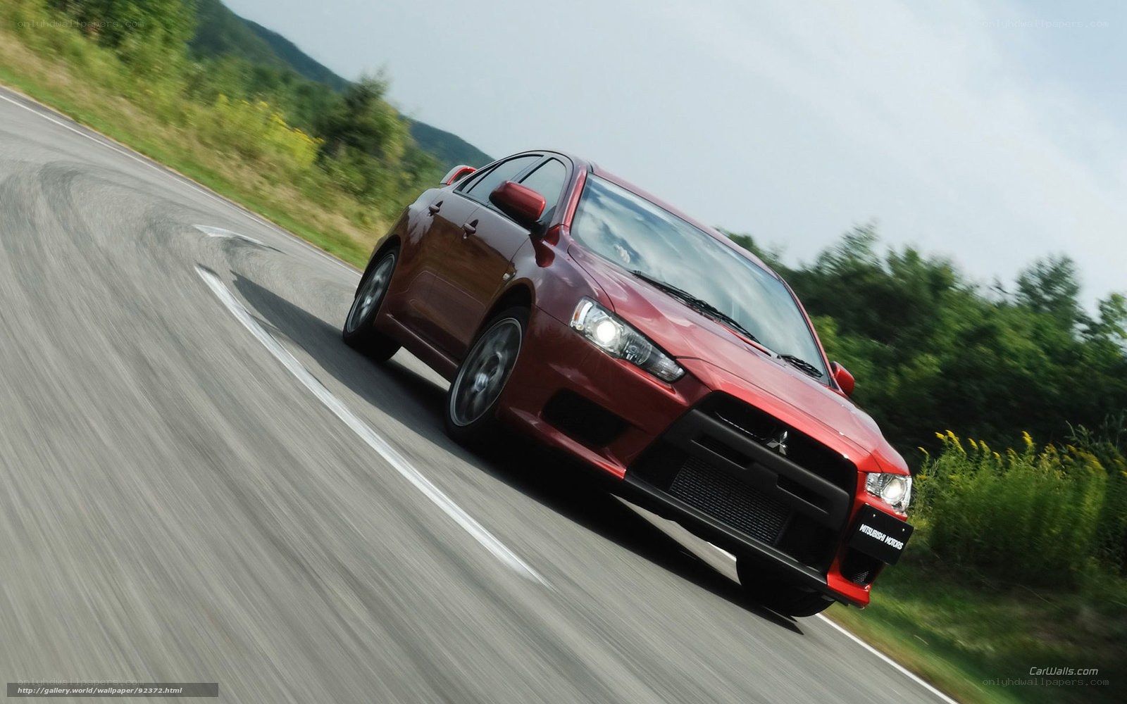 red mitsubishi on winding road