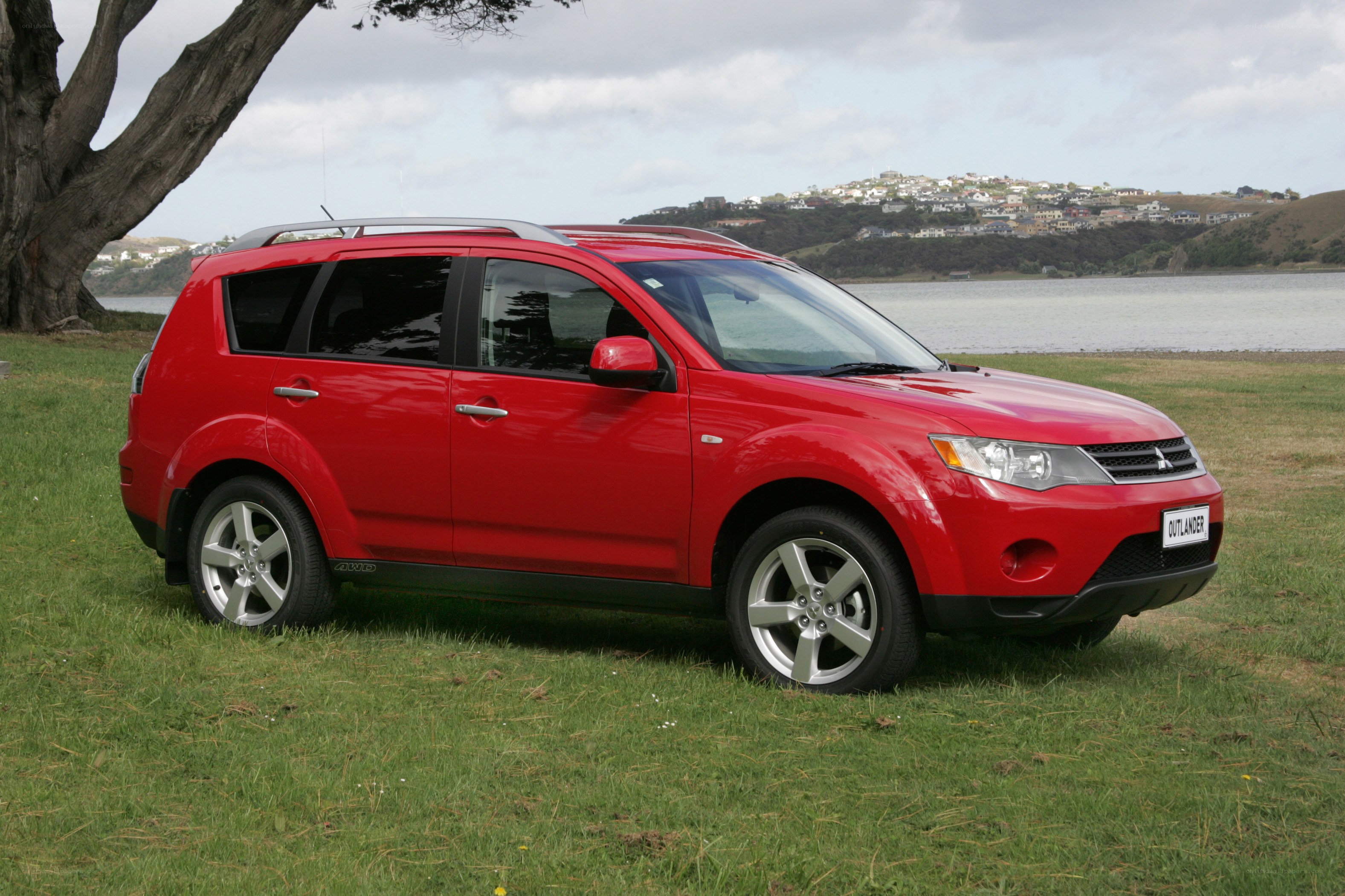 Red Mitsubishi Outlander on grass