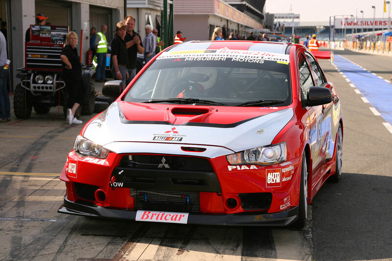 Red Mitsubishi rally car on track