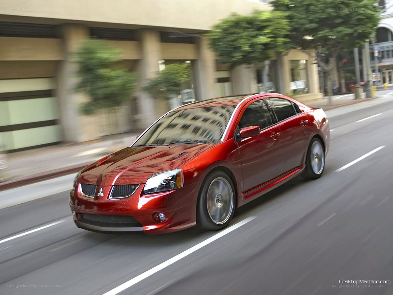 red mitsubishi sedan in motion