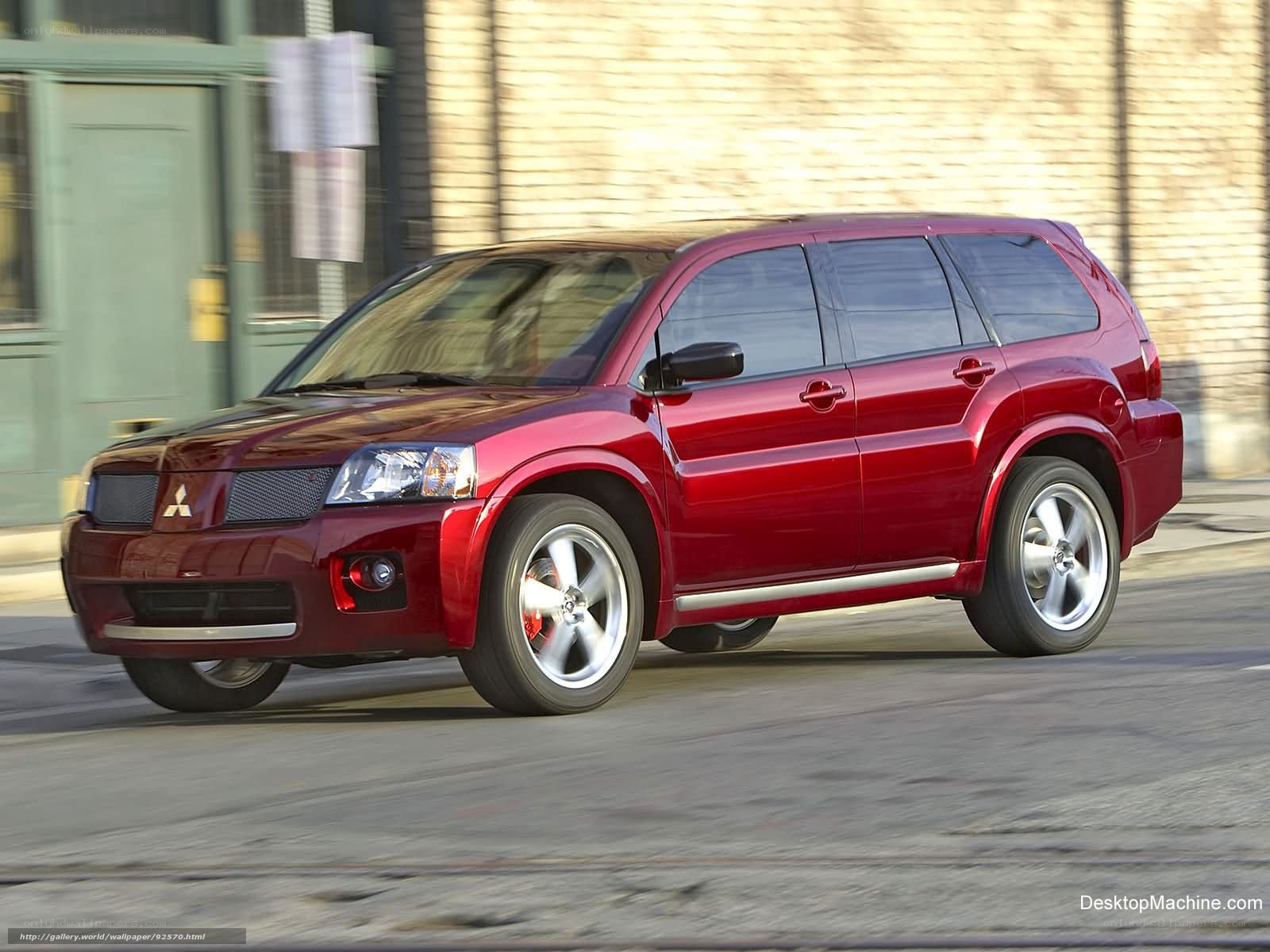 Red Mitsubishi SUV in motion