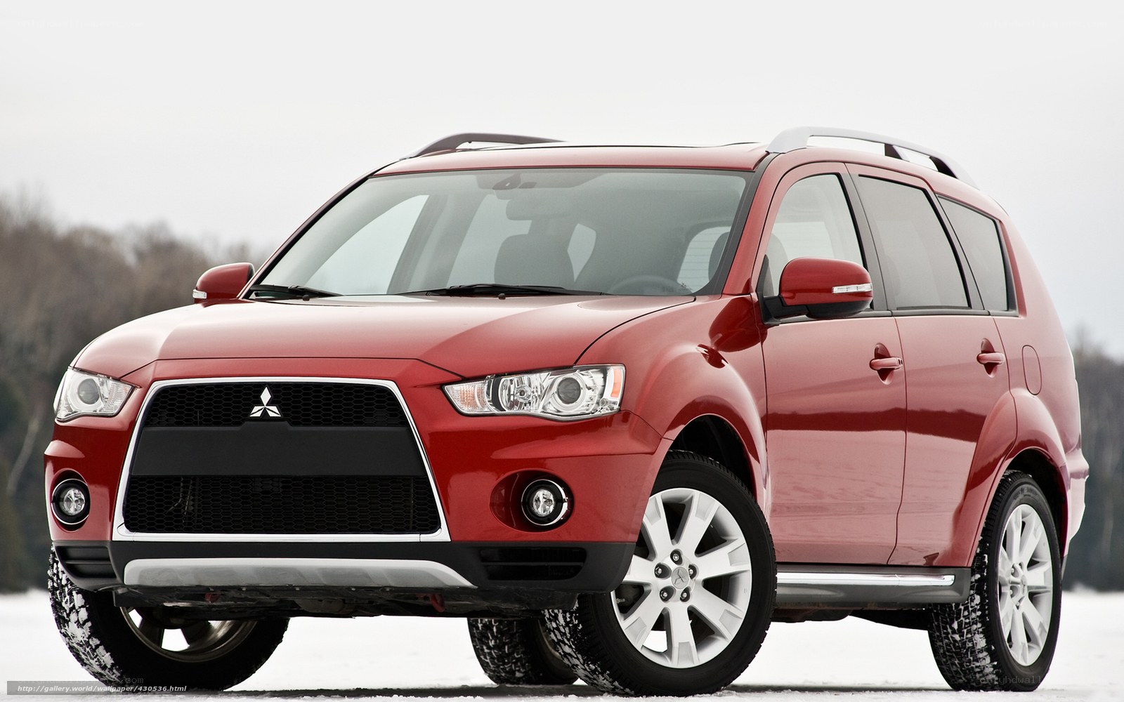Red Mitsubishi SUV in snow