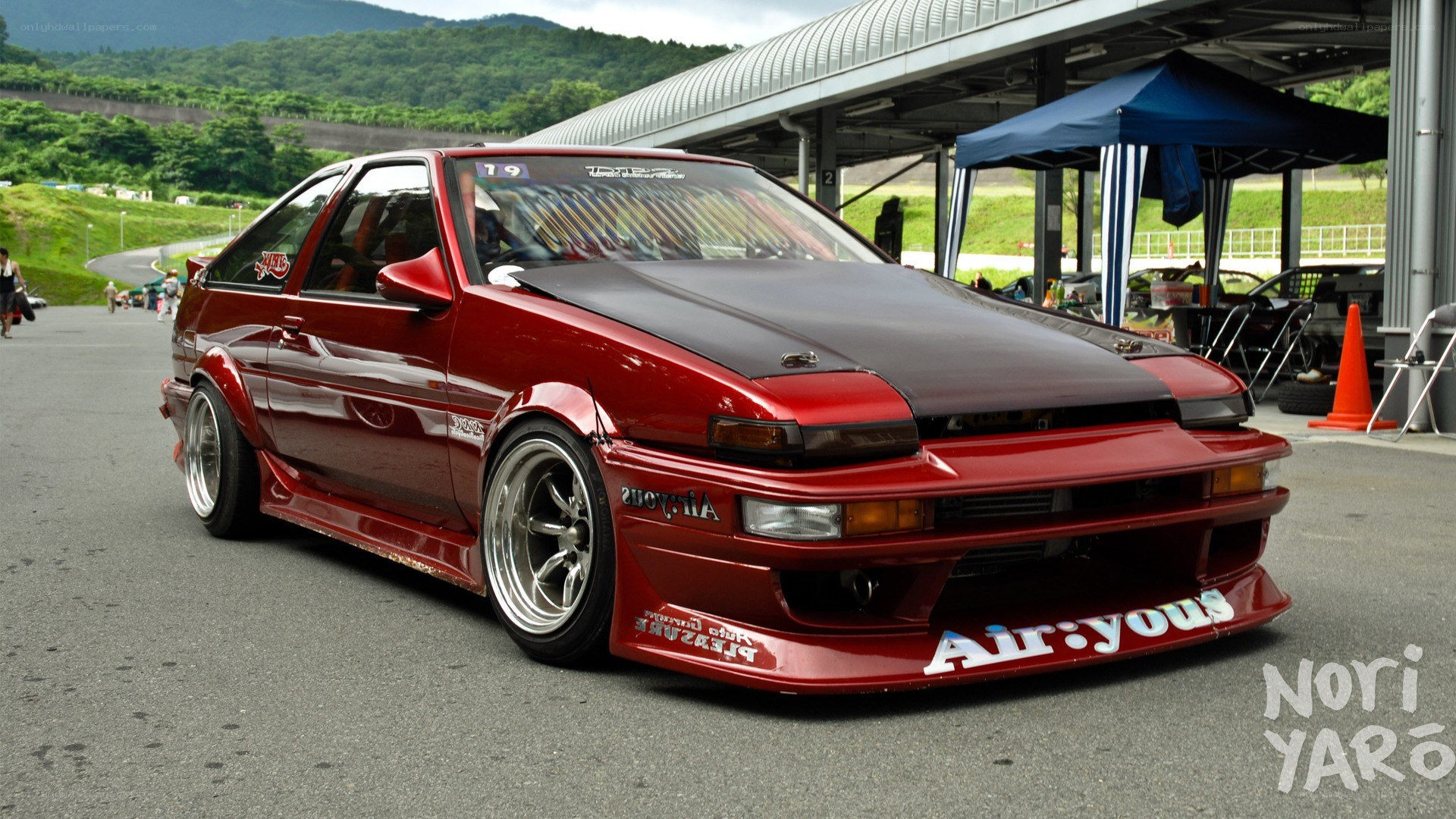 Red modified AE86 at a race track