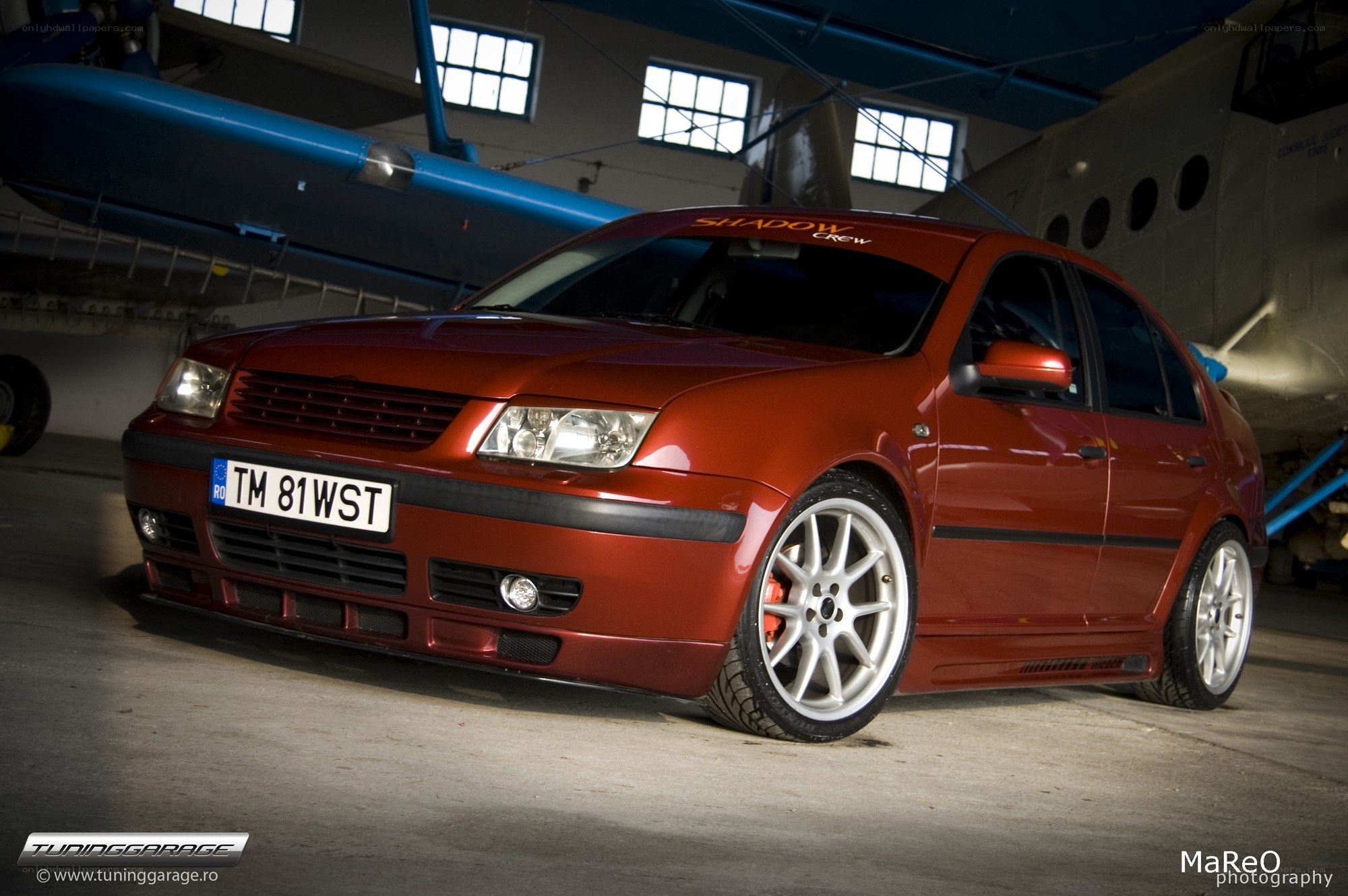 Red modified car in hangar