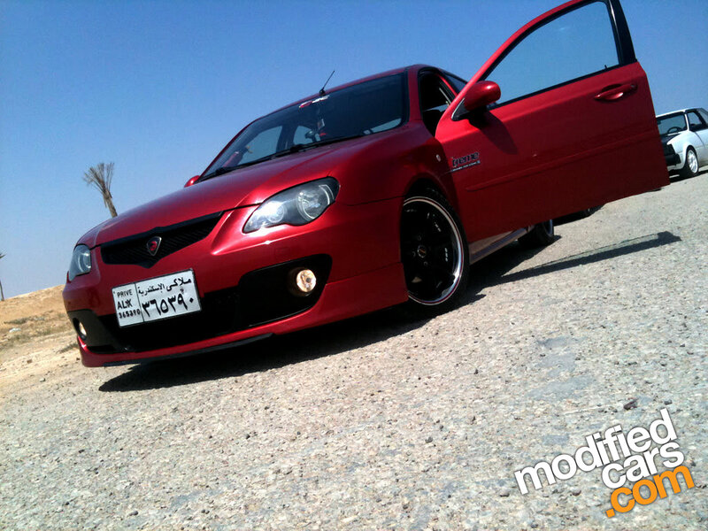 red modified car on gravel