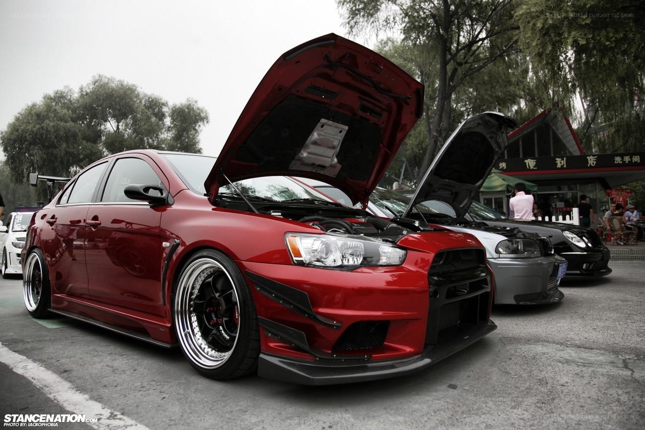 Red modified sedan at car show