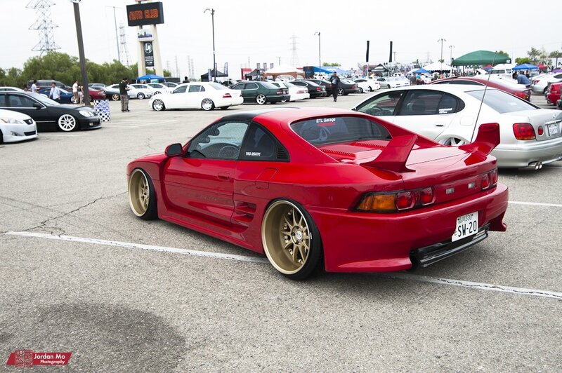 Red modified sports car at a show