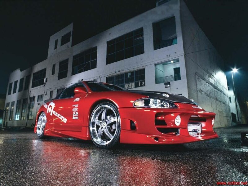 Red modified sports car at night