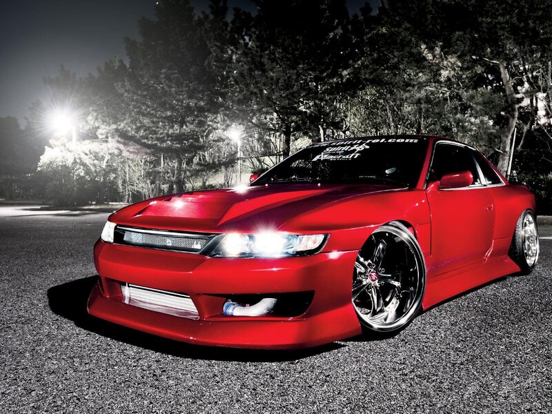red modified sports car at night