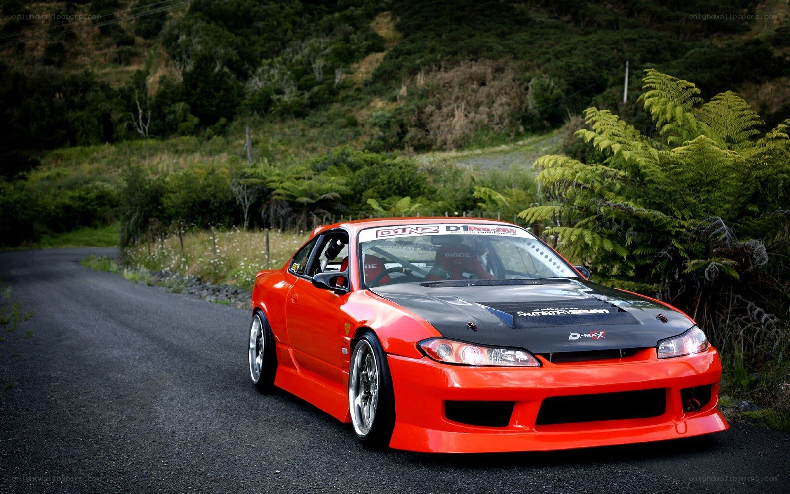 red modified sports car on road