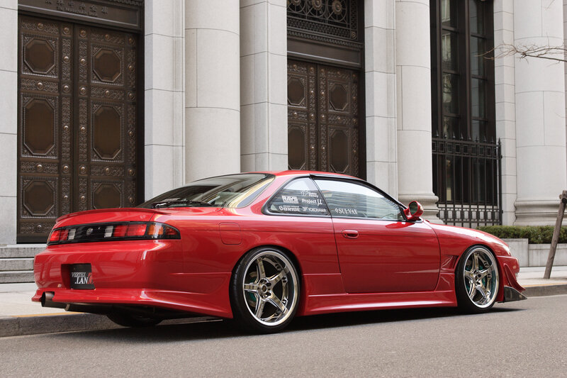 Red modified sports car on street