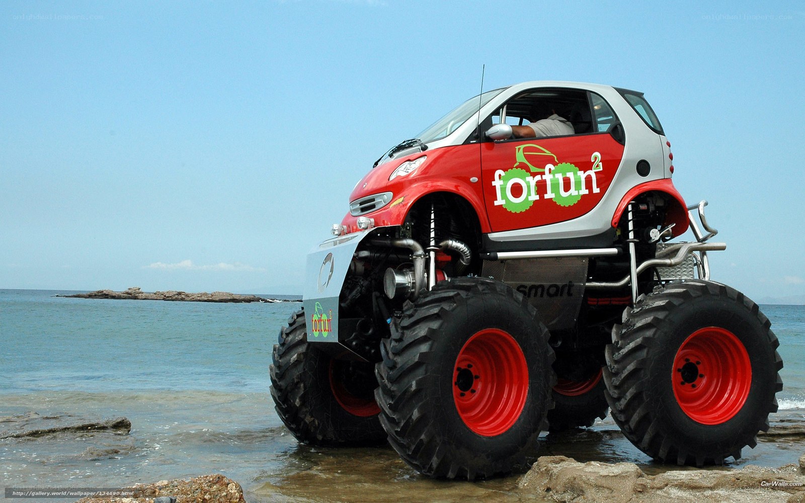 Red monster car on beach