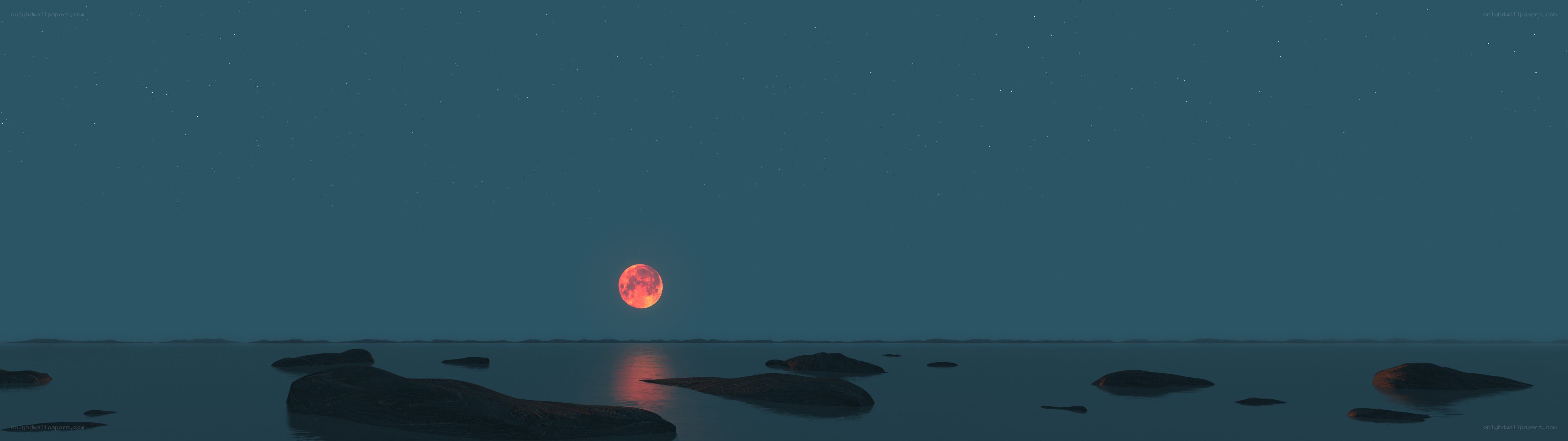 Red moon over calm sea