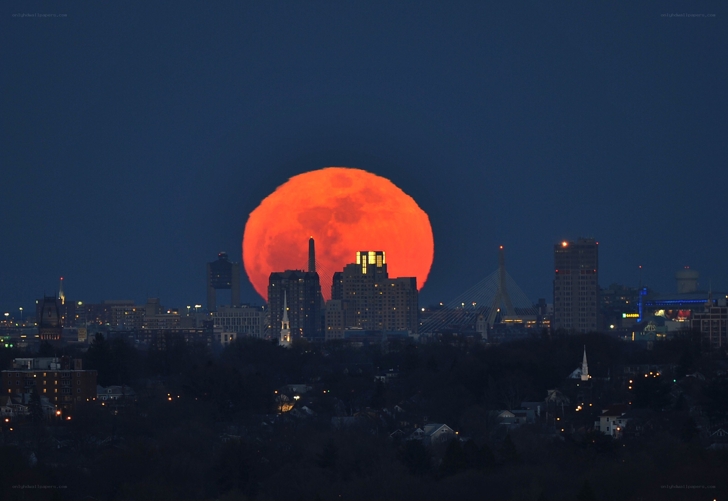 Red moon over city skyline
