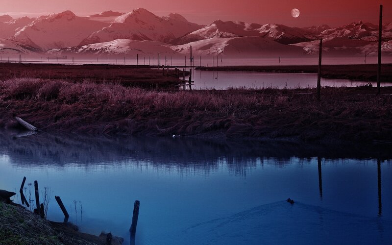 Red Moon Over Snowy Mountains