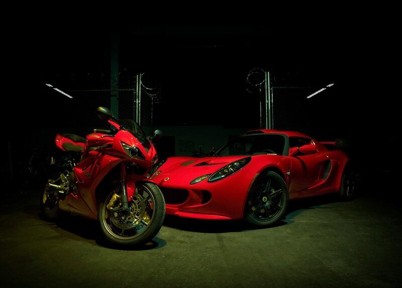 Red motorcycle and sports car