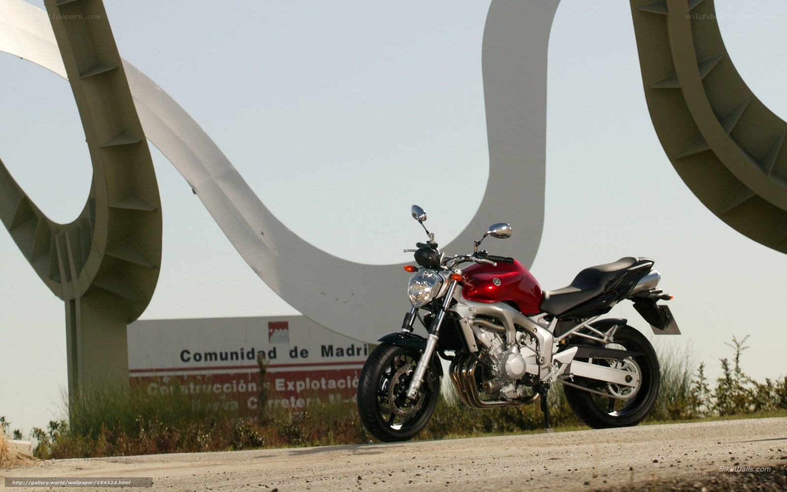 Red motorcycle at Madrid sign