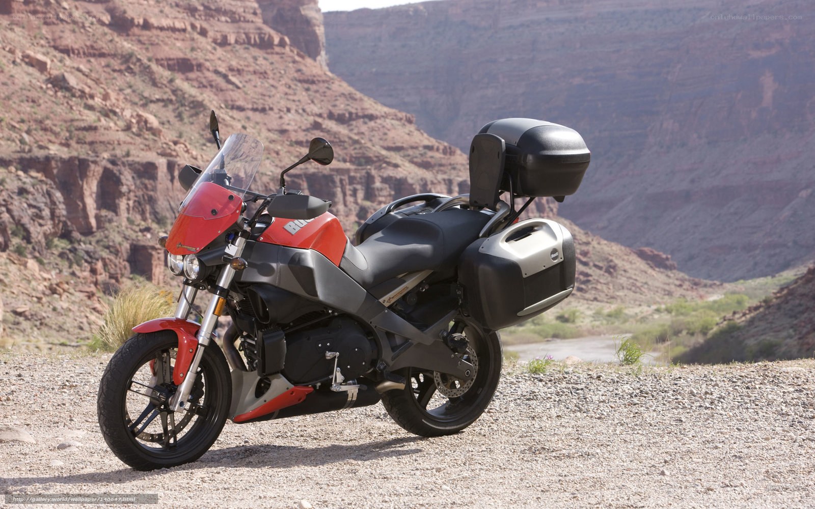 Red motorcycle in canyon landscape