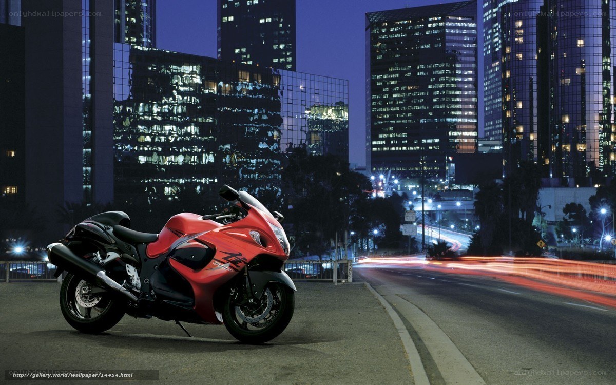 Red motorcycle in city at night