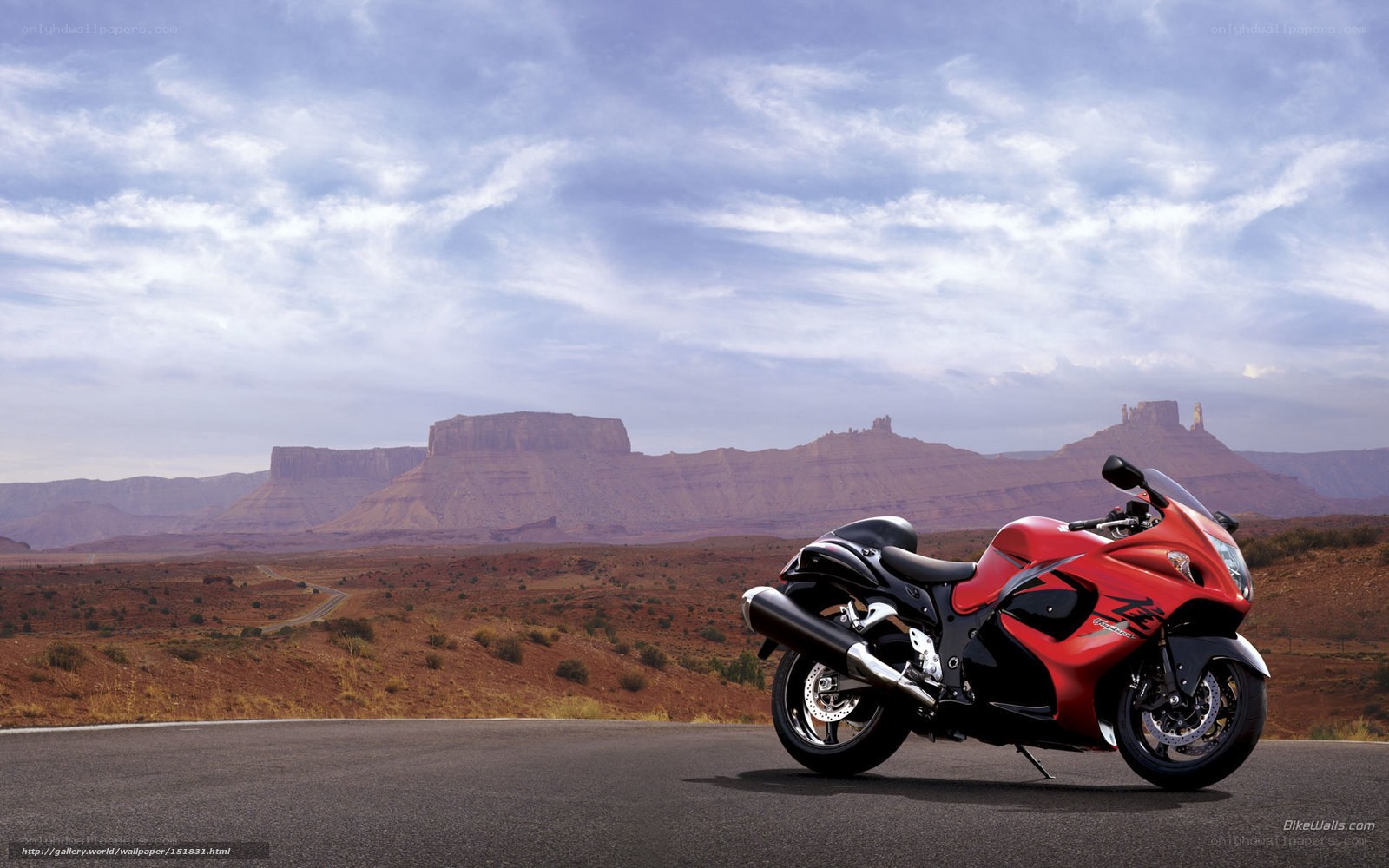 Red motorcycle in desert landscape
