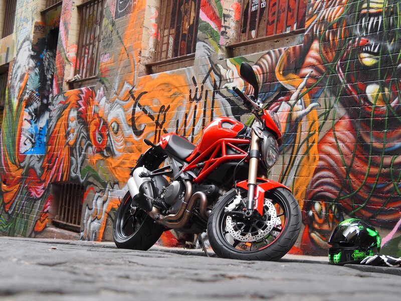 Red motorcycle in graffiti alley