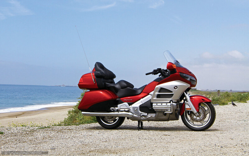 Red motorcycle on beach