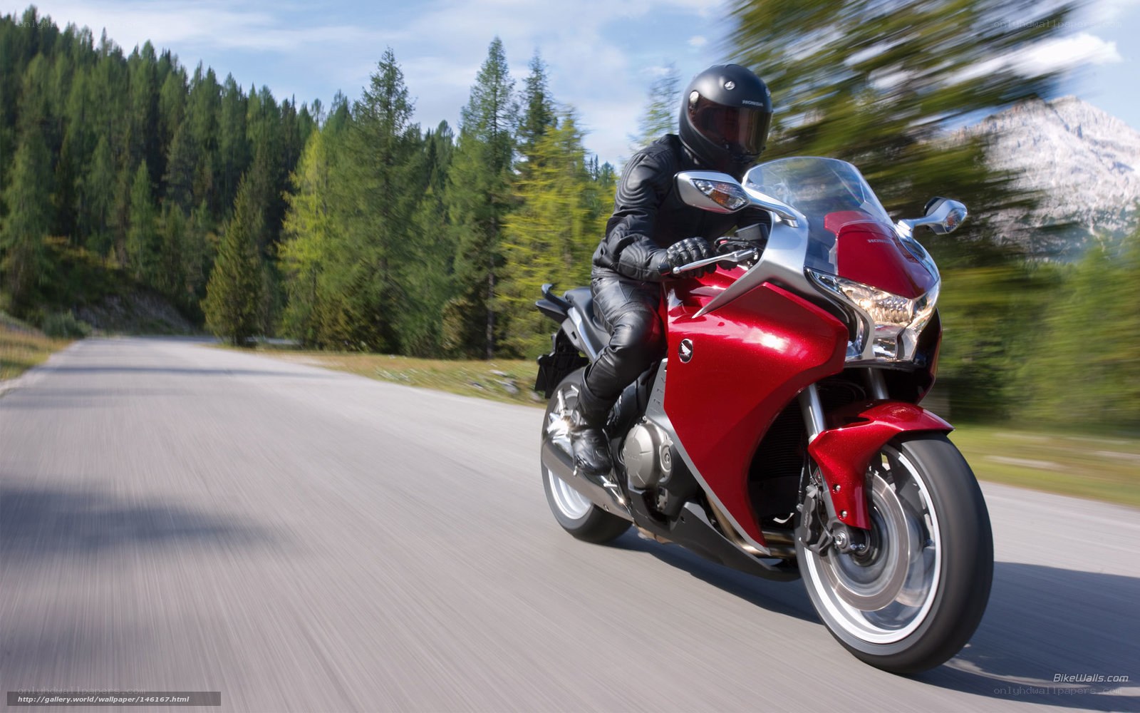 Red motorcycle on mountain road