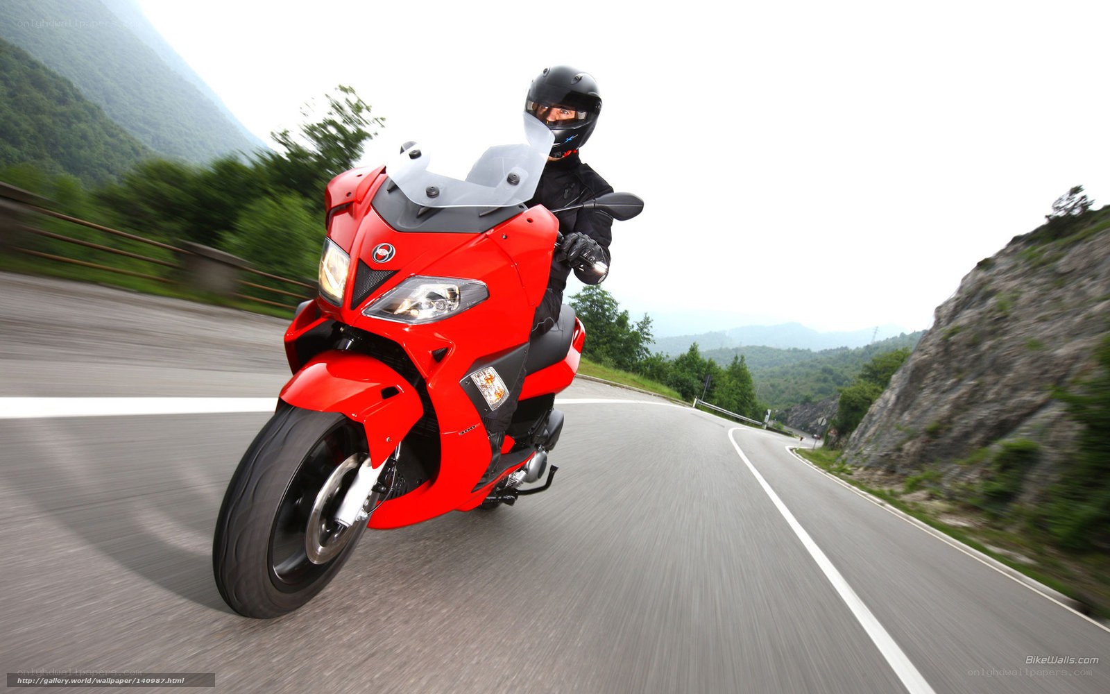 red motorcycle on mountain road