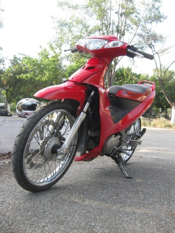 Red motorcycle on pavement