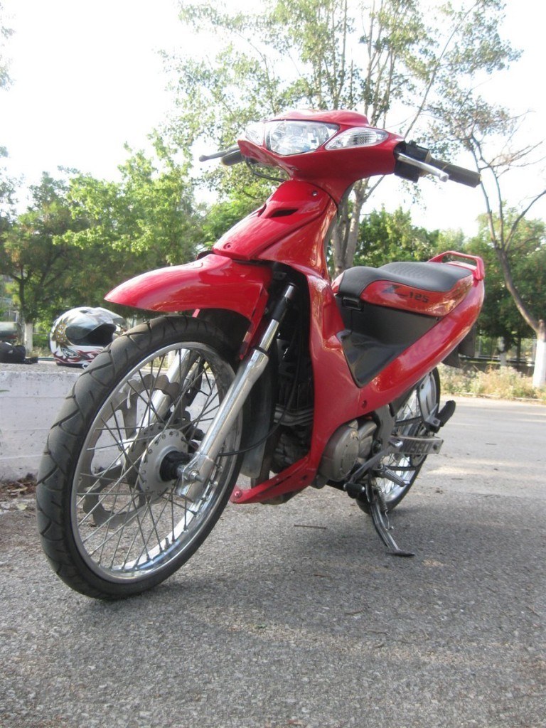 Red motorcycle on pavement