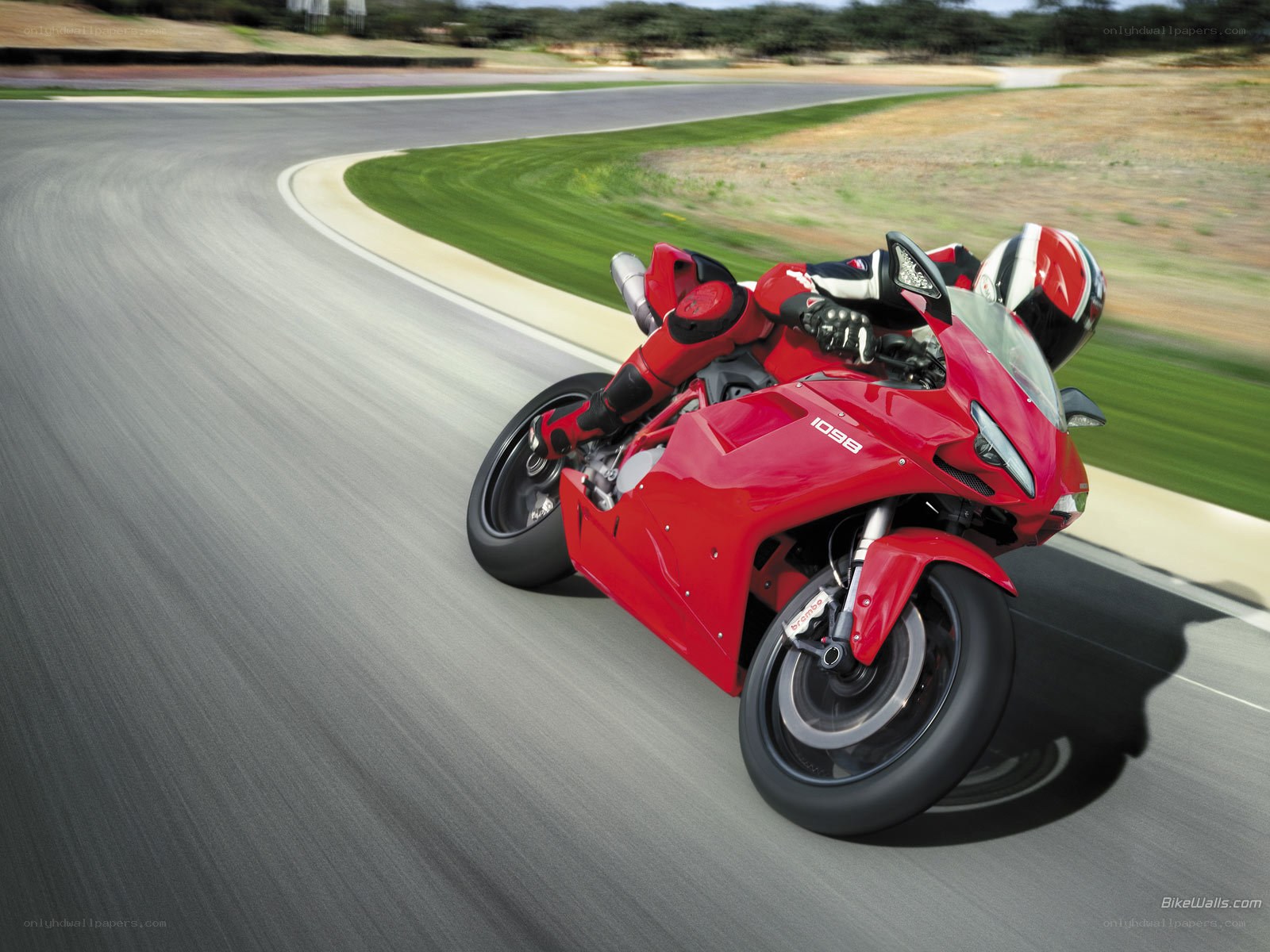 red motorcycle on racetrack