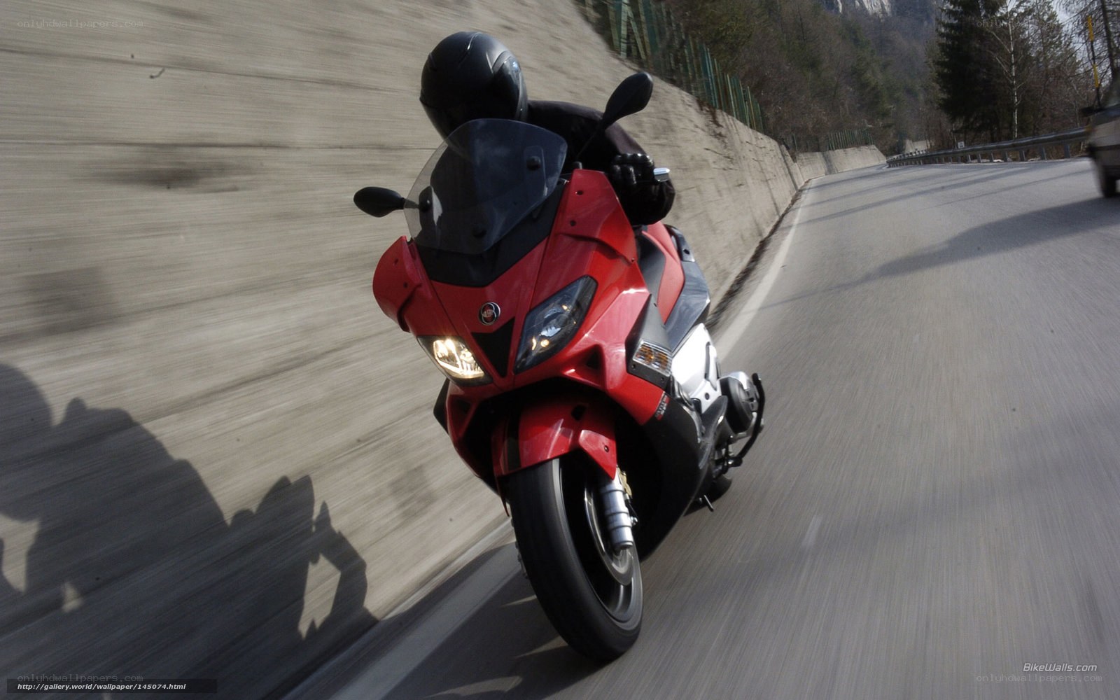 red motorcycle on winding road