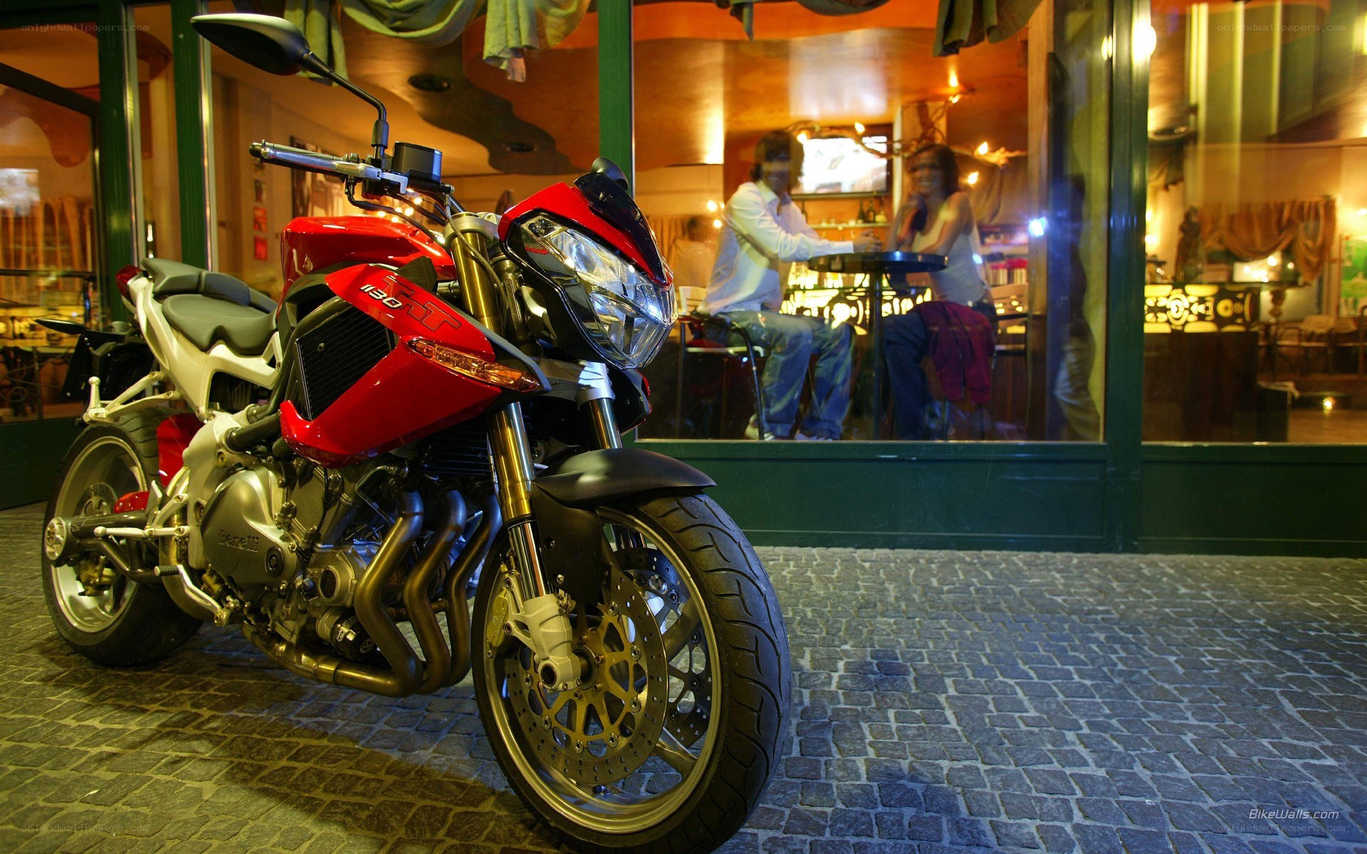 Red motorcycle outside cafe