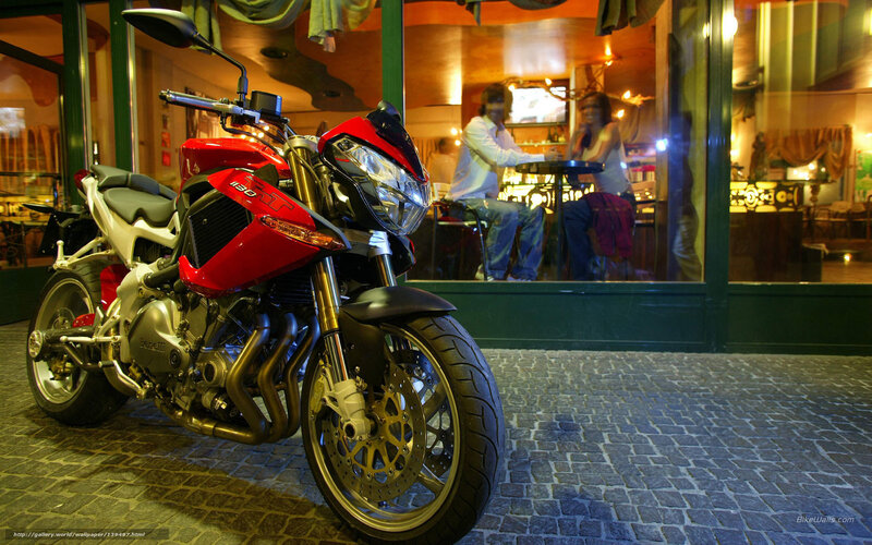 Red motorcycle outside cafe