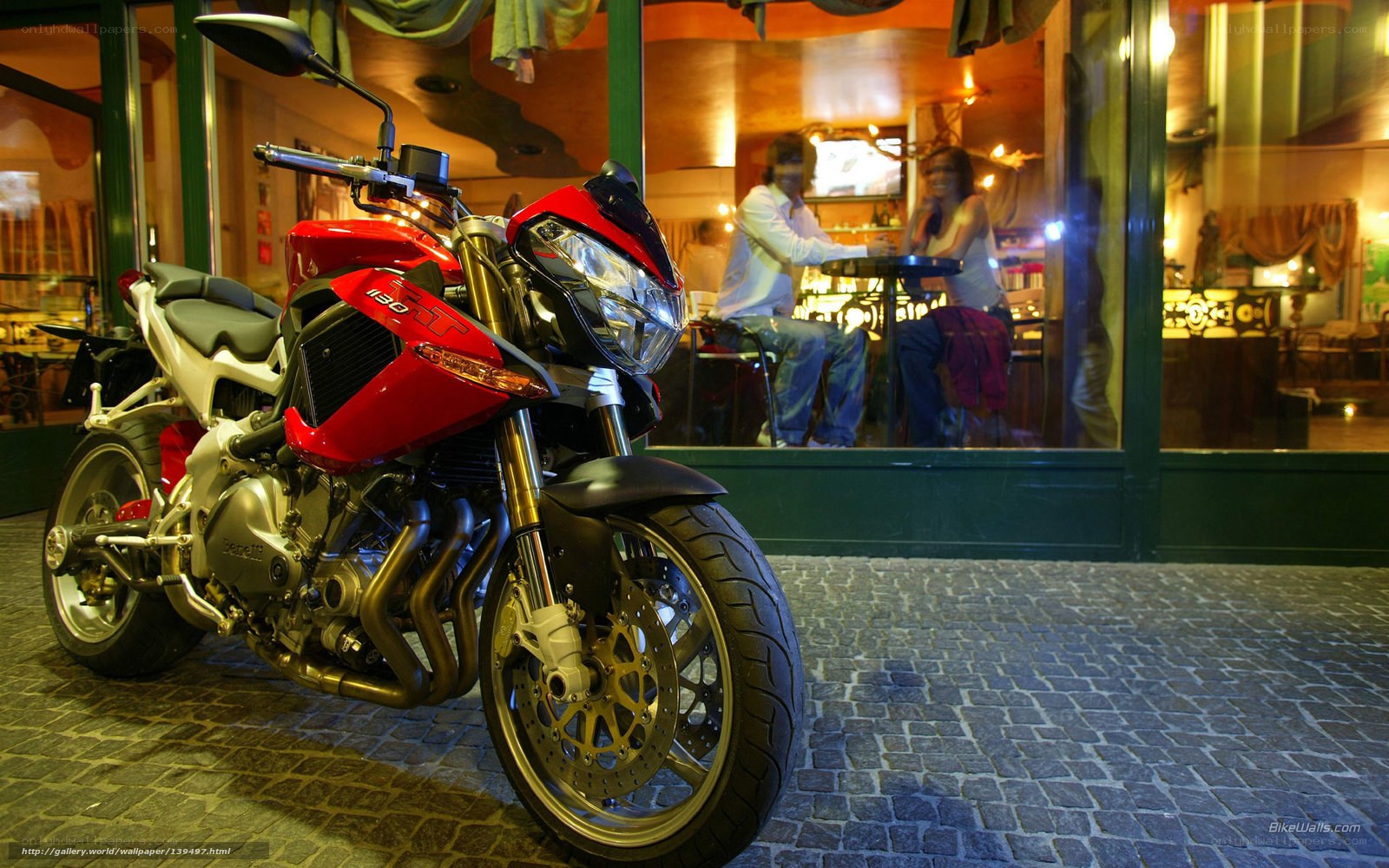 Red motorcycle outside cafe