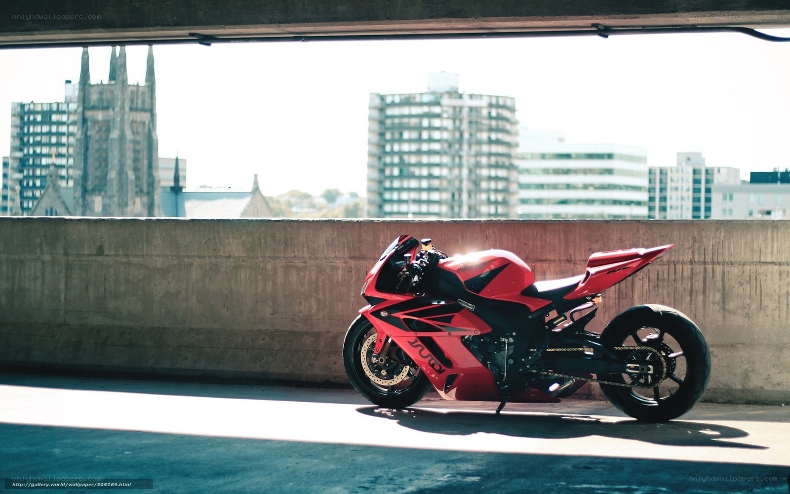 Red motorcycle under overpass