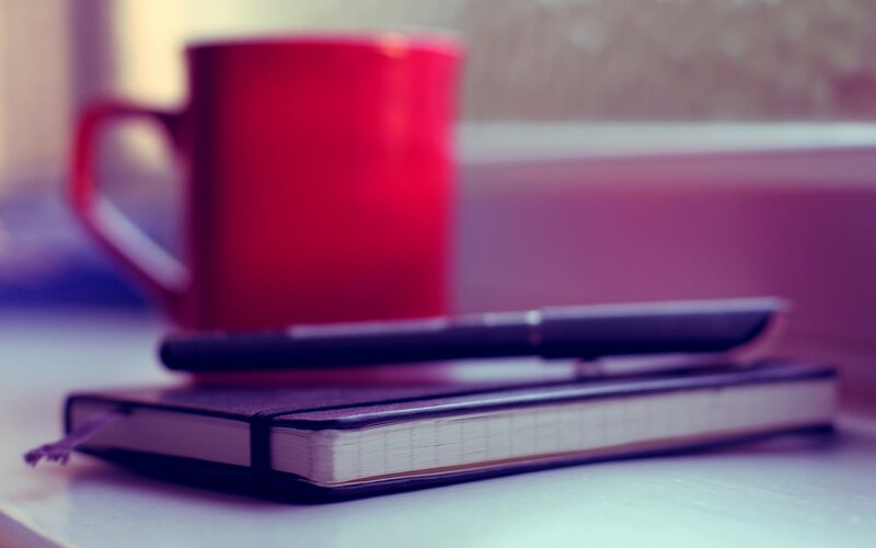 Red mug with notebook