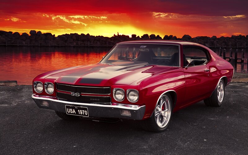 Red muscle car at sunset
