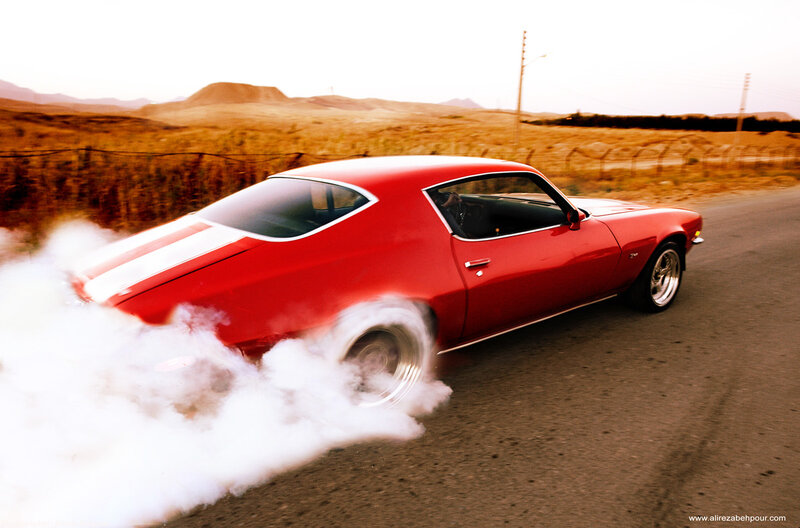 Red Muscle Car Burning Tire