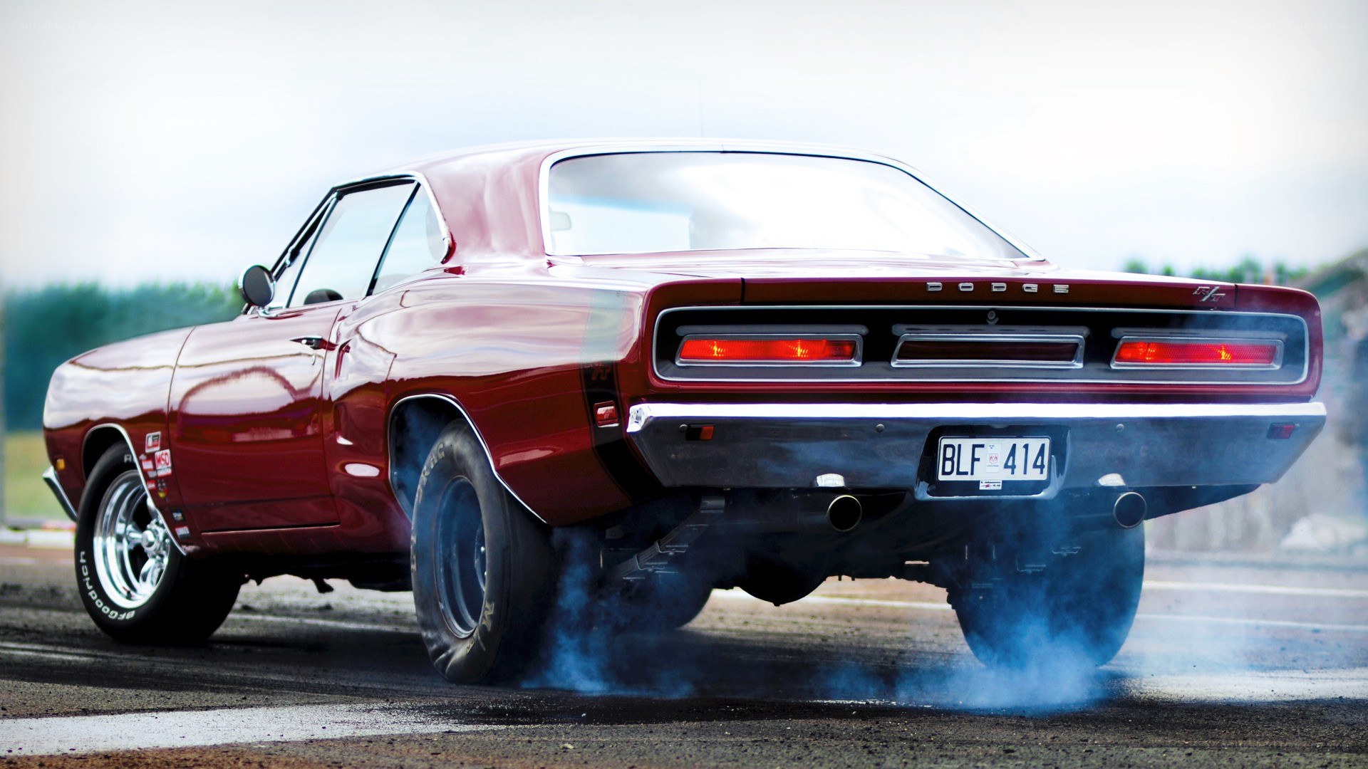 Red muscle car burnout