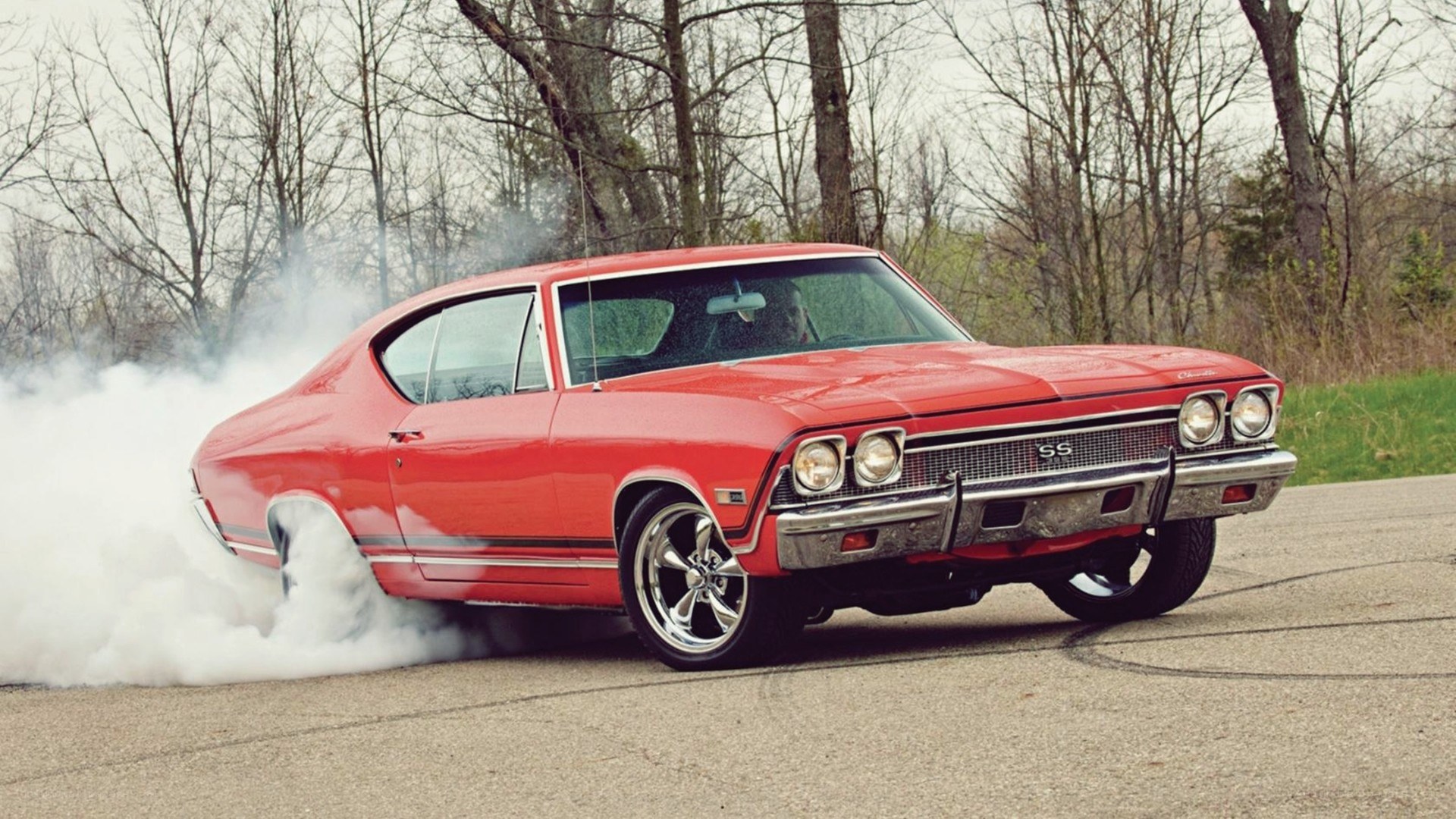 Red muscle car burnout