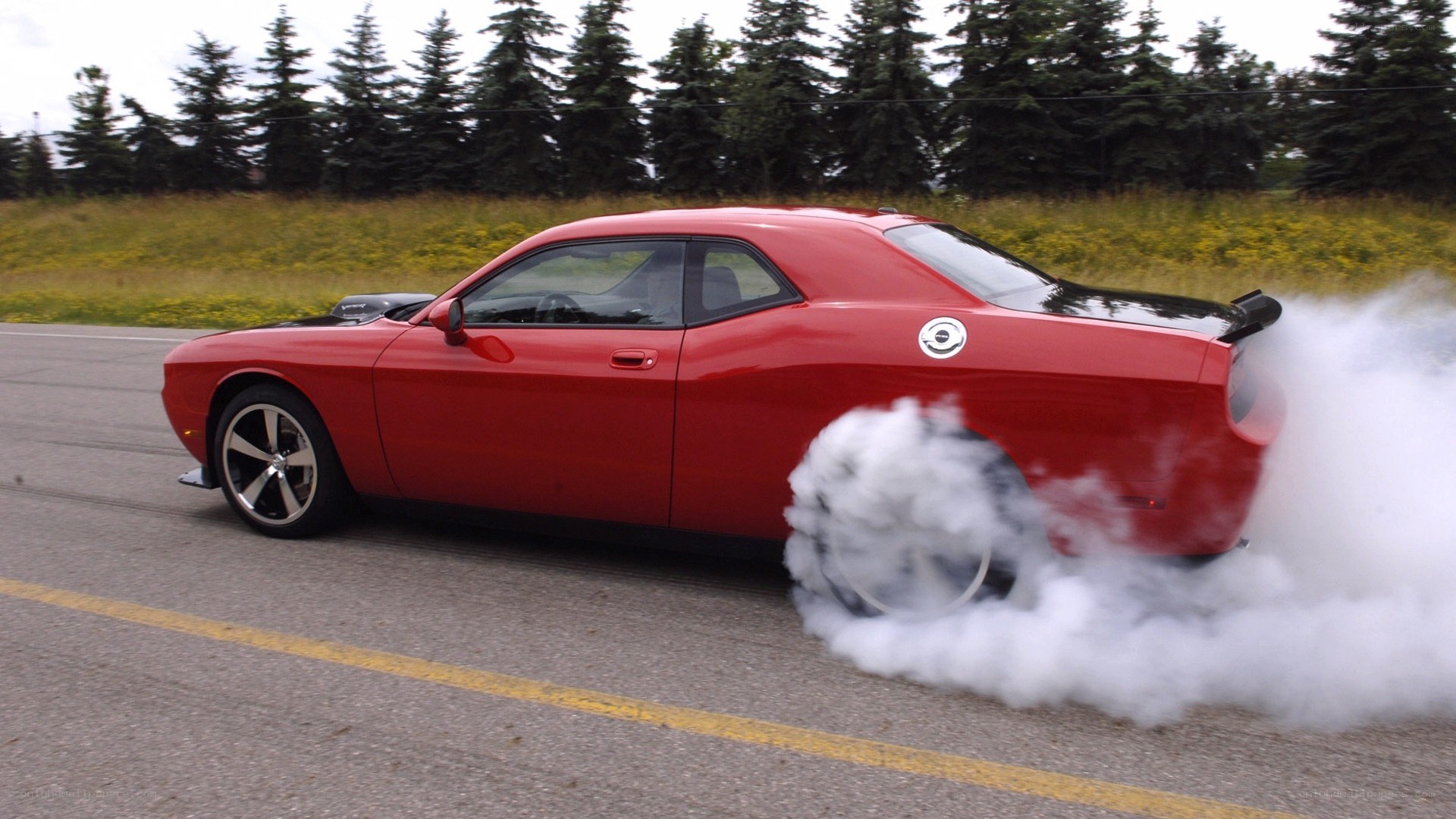 Red muscle car doing burnout