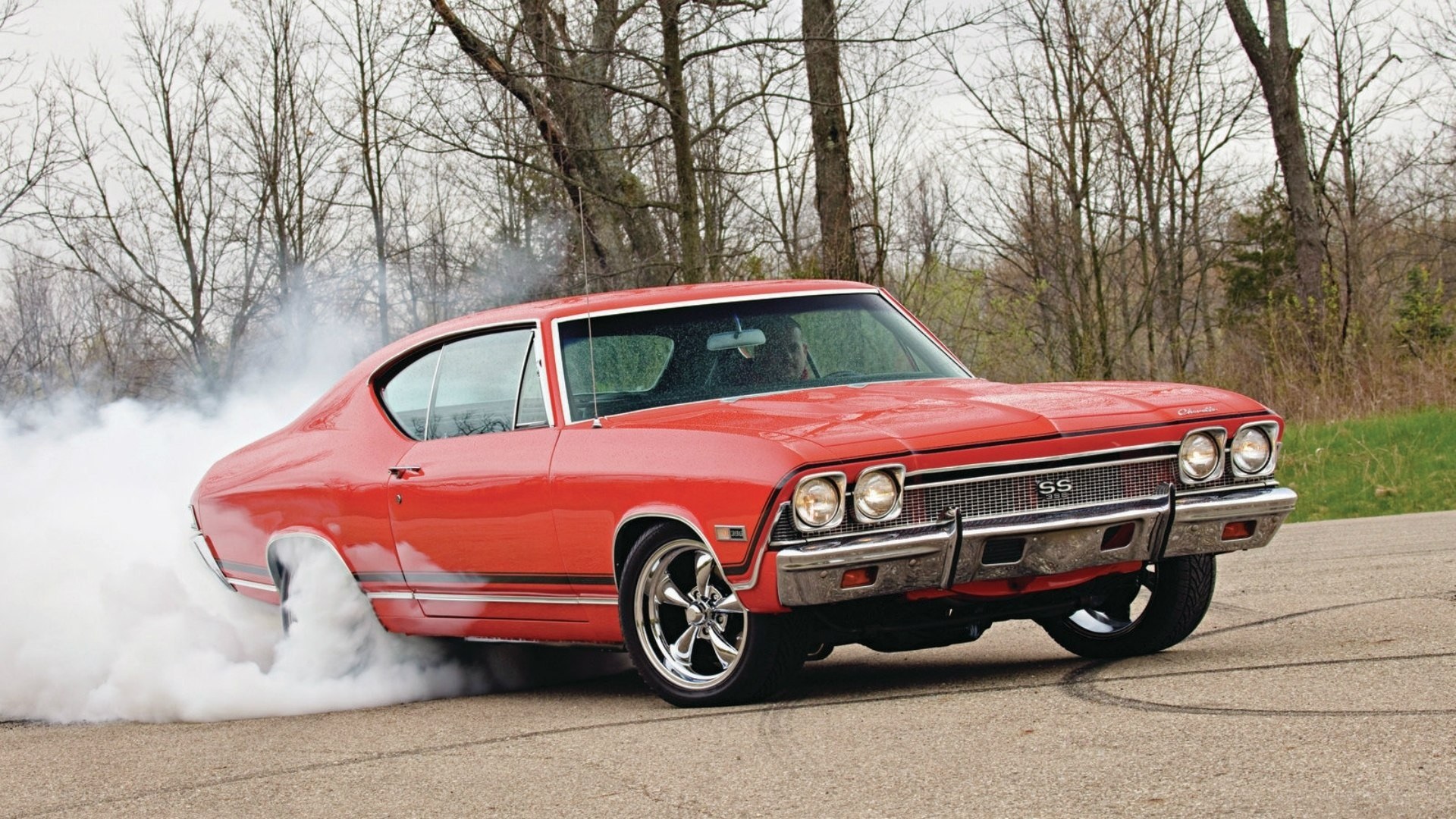 Red muscle car doing burnout