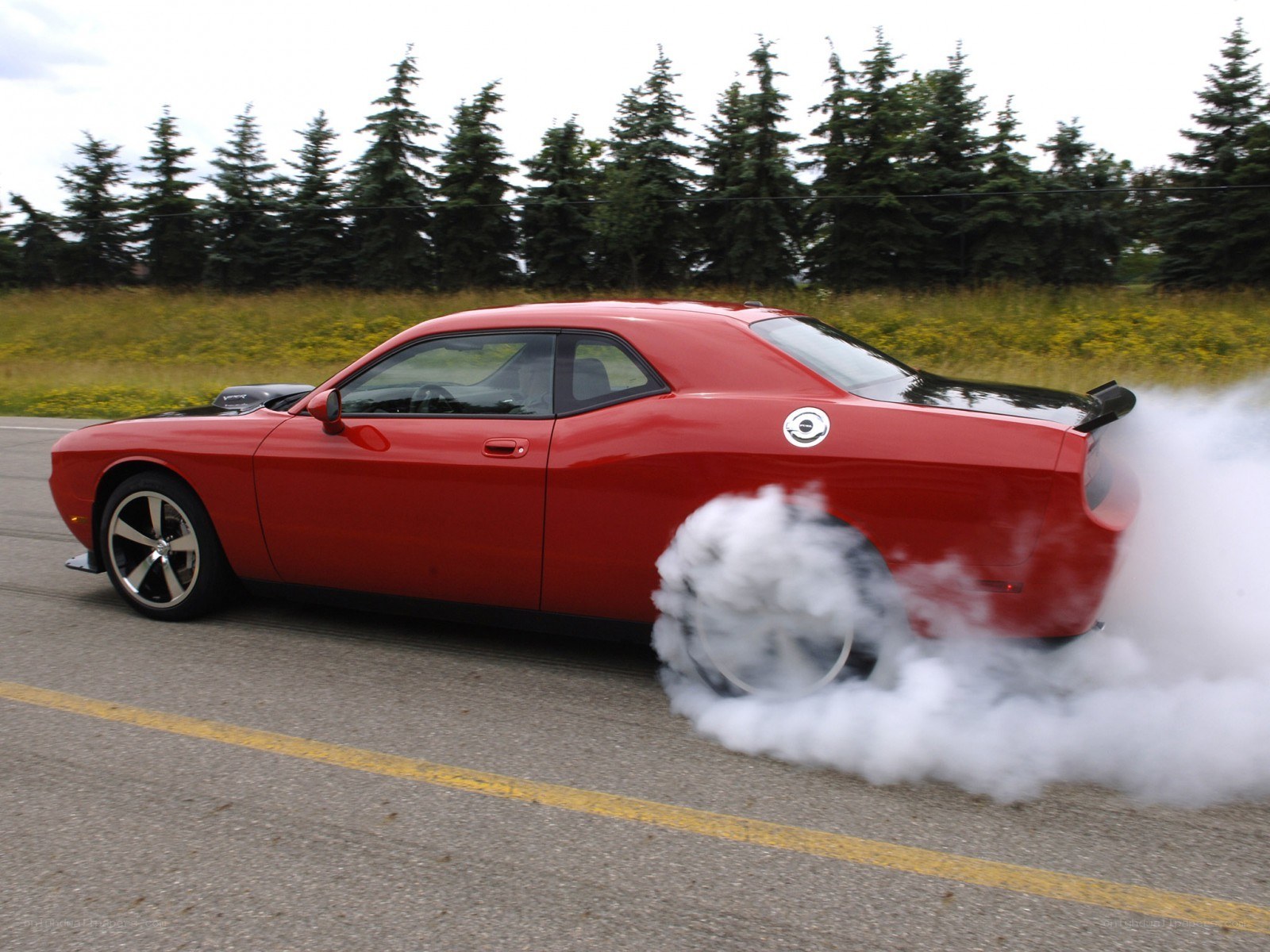 Red muscle car doing burnout