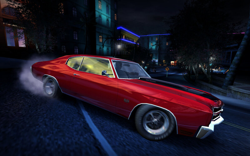 Red muscle car drifting at night