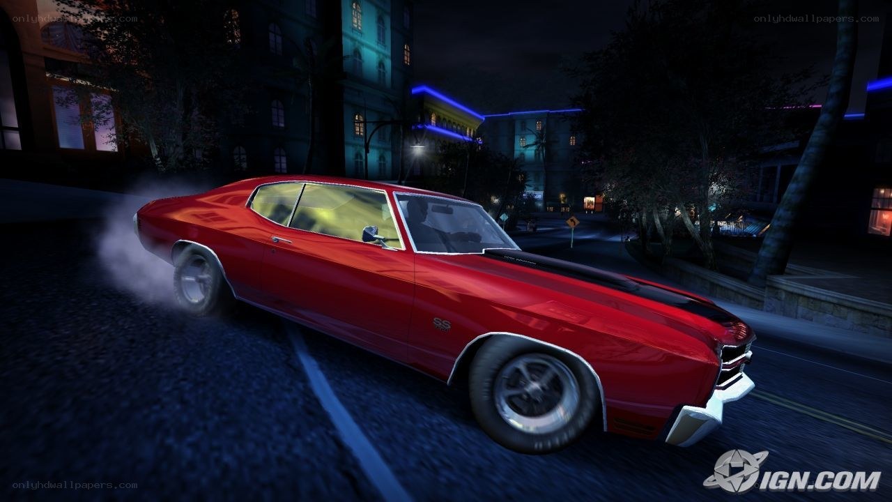 red muscle car drifting at night