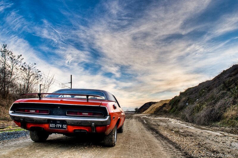 Red muscle car on a dirt road