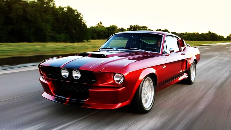 red muscle car on a road