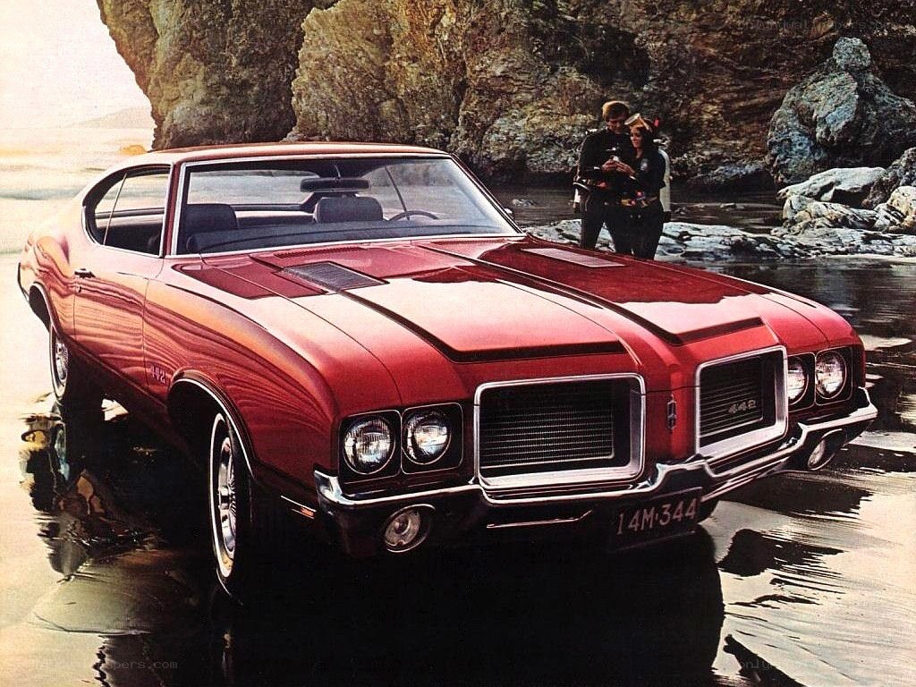Red muscle car on beach