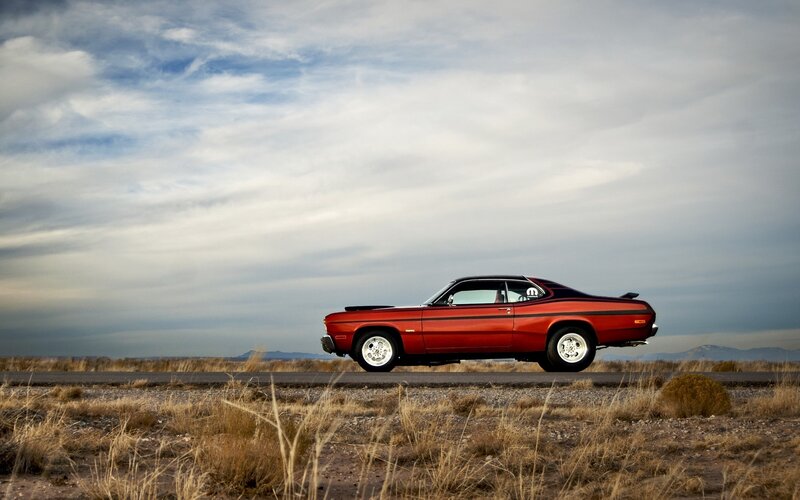 Red muscle car on desert road